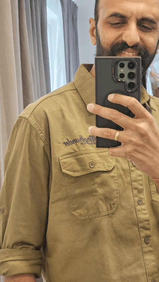 RTMC rider mirror-selfie in the olive XXV shirt showing the embroidered rollingthunder chest mark.