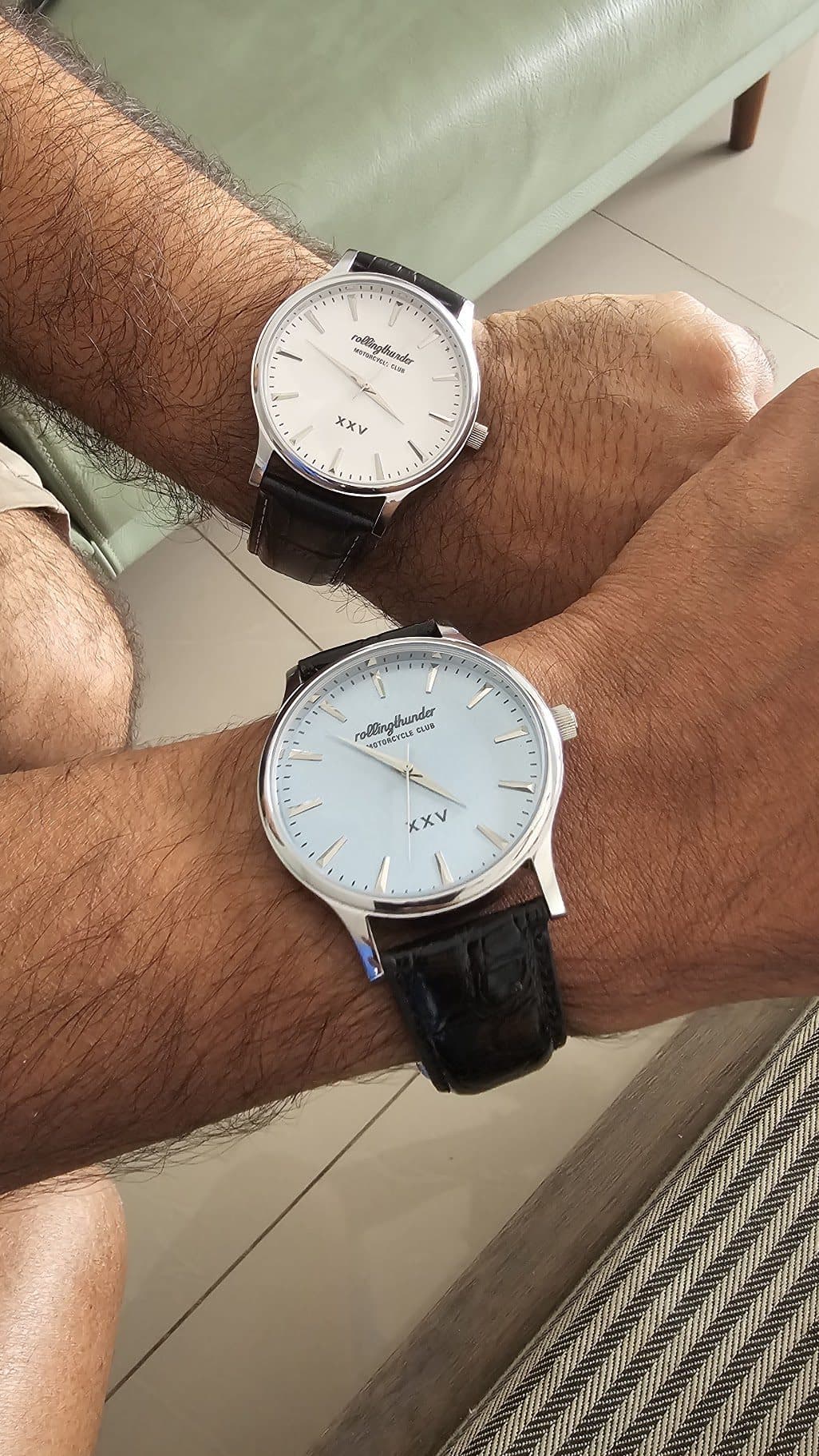 Two watches on wrist — the cream and the ice blue